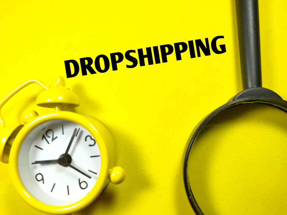 business-concepttext-dropshipping-with-magnifying-glass-clock-yellow-background